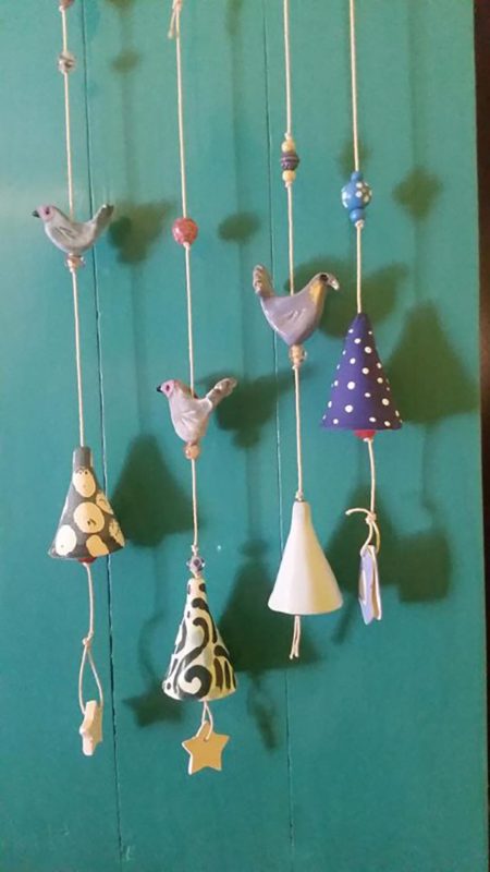 Birds made out of clay on strings