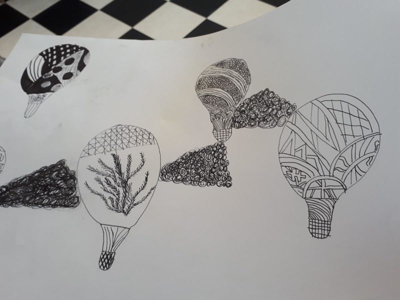 Black and white drawing of abstract lightbulbs