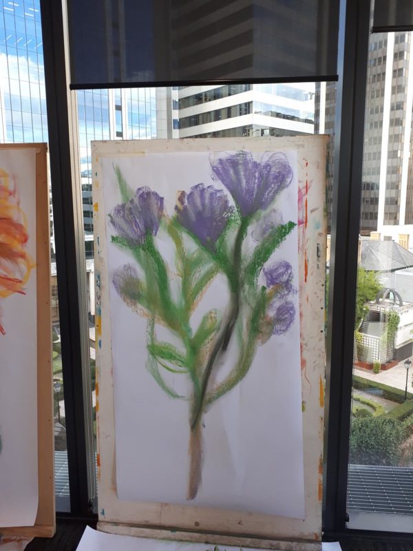 Drawing of lilac flowers in front of a city view