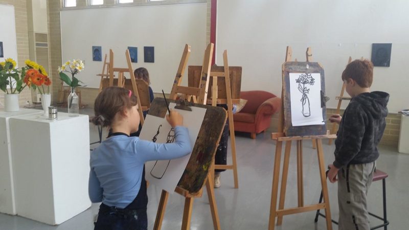 Children with painting easels