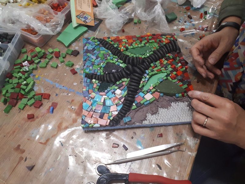 Woman working on a mosaic