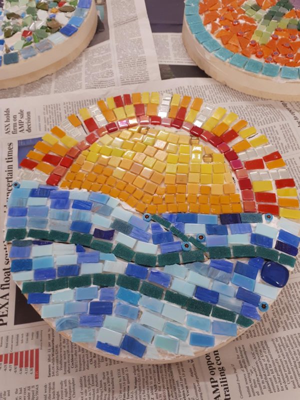 Mosaic paver with a sunset over the ocean