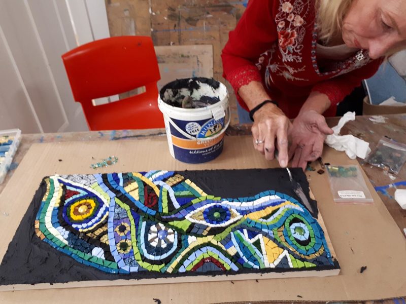 Woman working on her mosaic