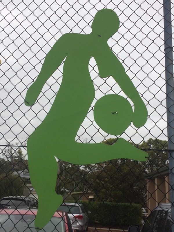 Fence with colourful athlete silhouette attached