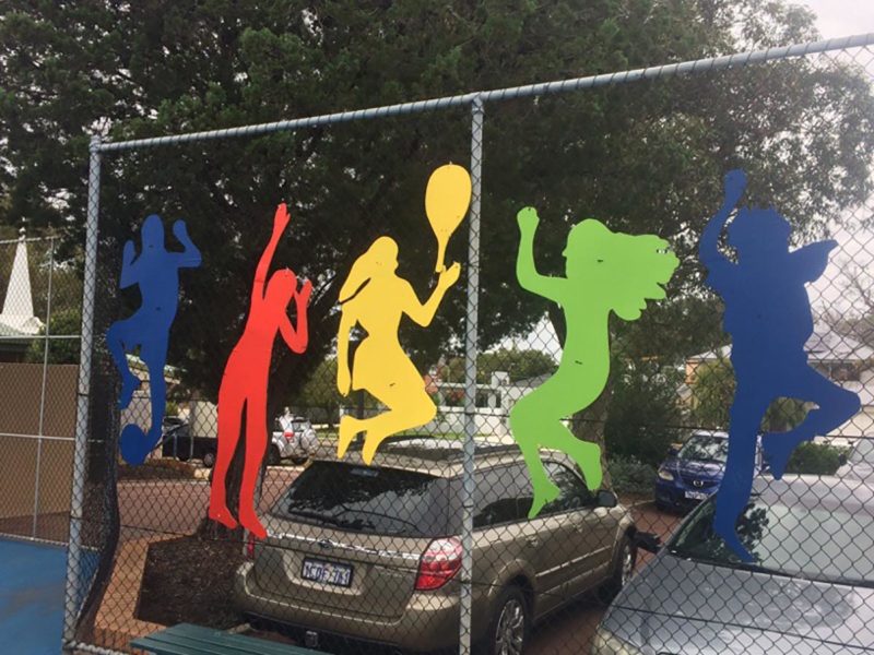 Fence with colourful athlete silhouettes attached