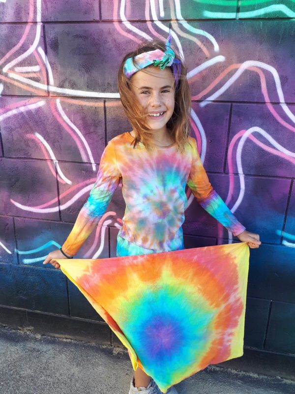 Child with tie-dye fabric