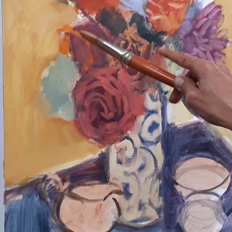 Hand painting a vase full of flowers