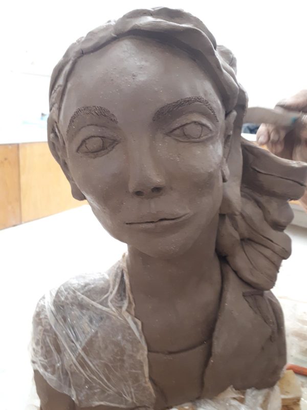Brown clay sculpture of a woman's head