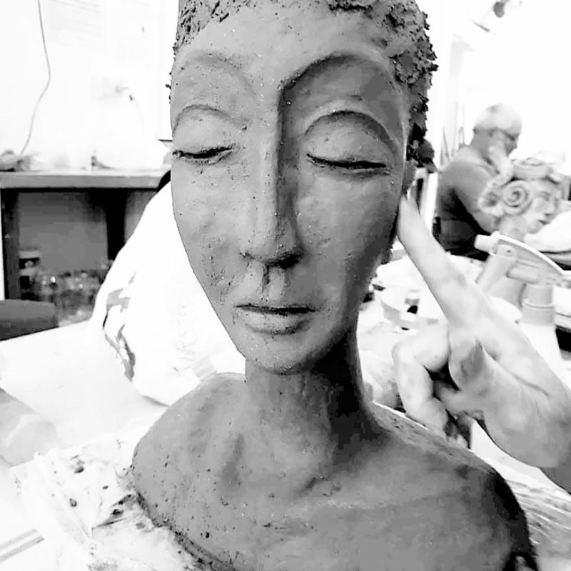 Clay sculpture of a woman's head a shoulders
