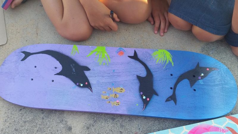 Painting on a skateboard deck of sea life
