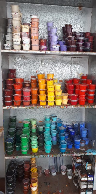 Cabinet full of jars of coloured paint